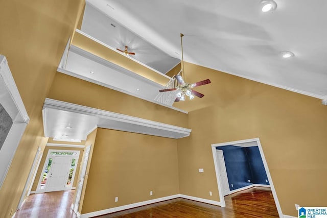 interior space with high vaulted ceiling, hardwood / wood-style floors, and ceiling fan