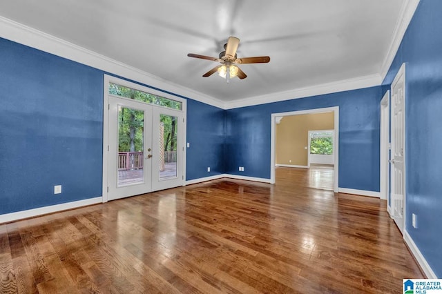 unfurnished room featuring hardwood / wood-style floors, ornamental molding, french doors, and a healthy amount of sunlight