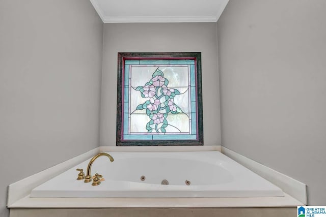 bathroom with ornamental molding and a bath