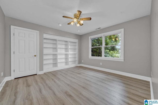 unfurnished bedroom with ceiling fan and light hardwood / wood-style floors