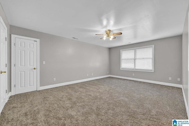 carpeted spare room with ceiling fan