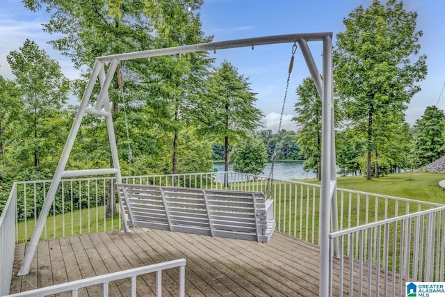 wooden deck with a lawn and a water view