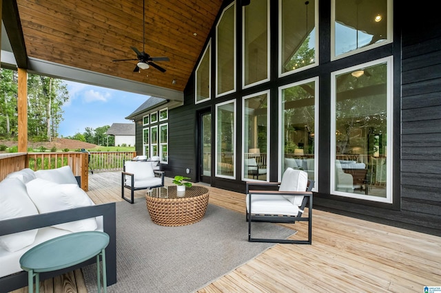 wooden terrace with an outdoor hangout area and ceiling fan