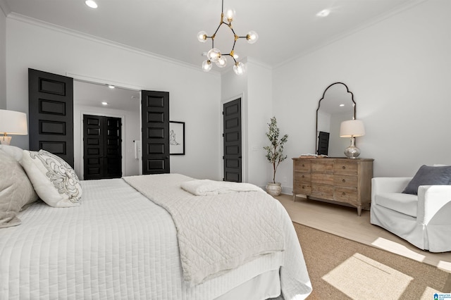 bedroom with hardwood / wood-style flooring, ornamental molding, and a notable chandelier