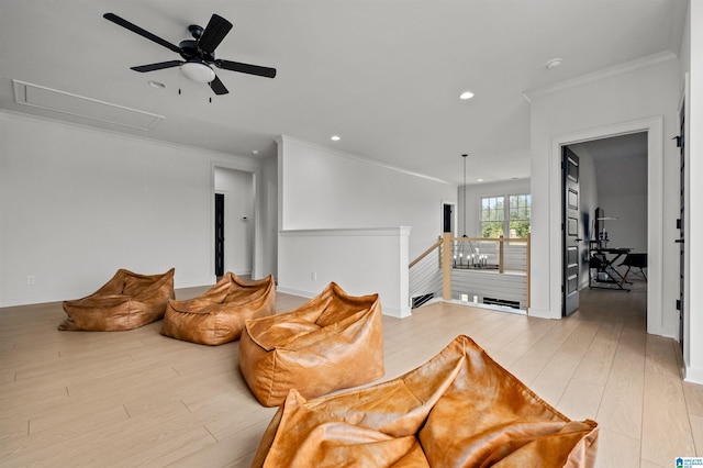 sitting room with crown molding, light hardwood / wood-style flooring, and ceiling fan