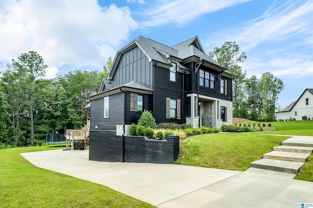 view of front of property featuring a front yard and a trampoline