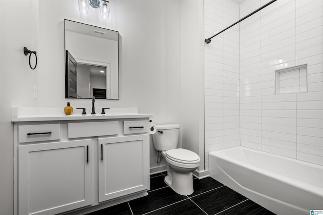 full bathroom with tiled shower / bath combo, vanity, and toilet