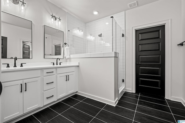 bathroom featuring vanity, tile patterned flooring, and a shower with door