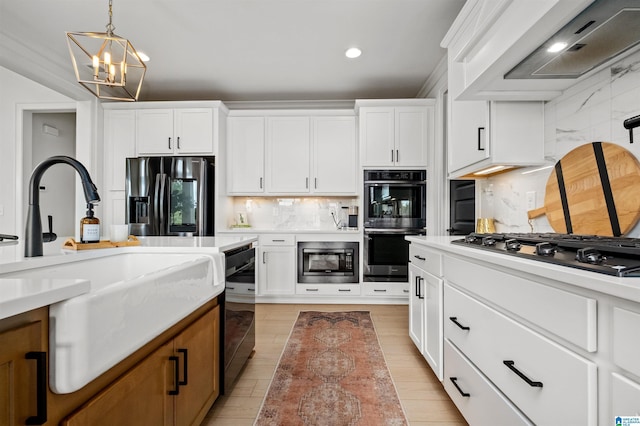 kitchen featuring stainless steel appliances, white cabinetry, hanging light fixtures, and backsplash