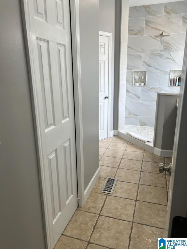 bathroom with a tile shower