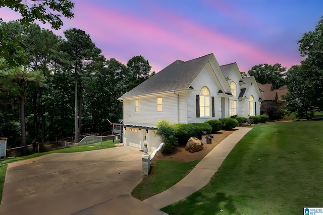 view of front of house featuring a garage and a yard