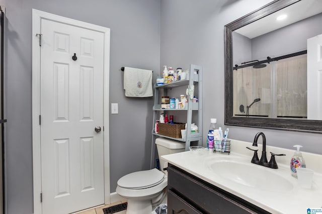 bathroom with tile patterned floors, toilet, a shower with shower door, and vanity