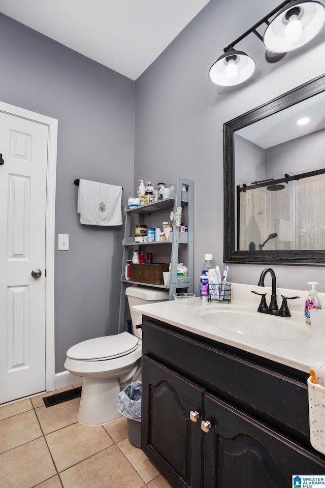 bathroom with vanity, toilet, curtained shower, and tile patterned flooring