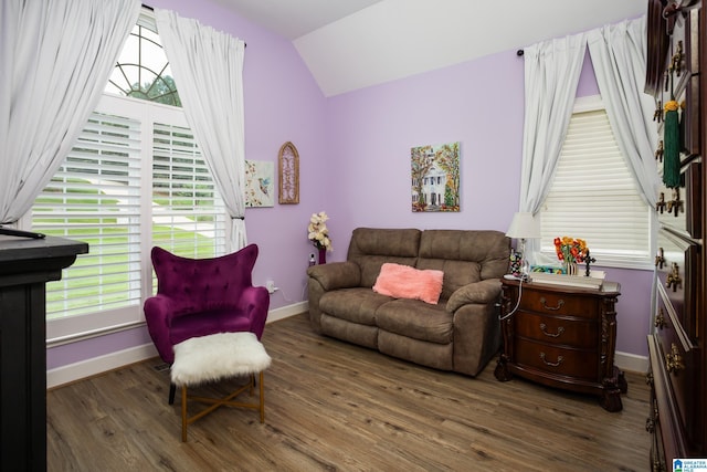 living room featuring lofted ceiling, plenty of natural light, and dark hardwood / wood-style floors