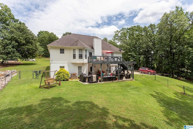 back of house with a patio area, a lawn, and a deck