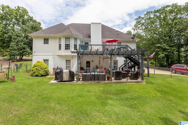 rear view of property featuring a patio, a lawn, and a pergola