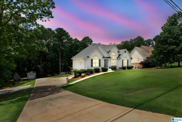 view of front of house featuring a shed and a lawn