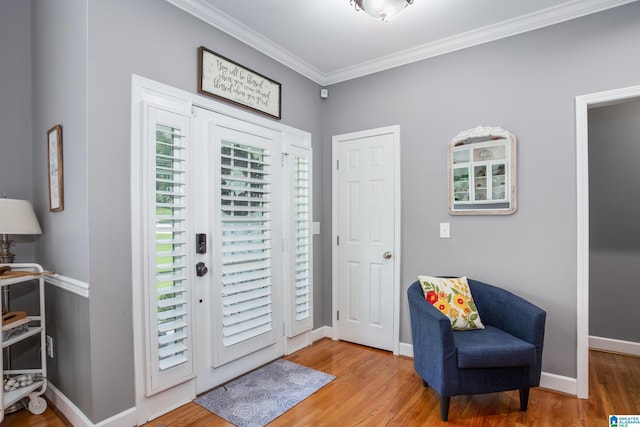 entrance foyer featuring ornamental molding and wood-type flooring