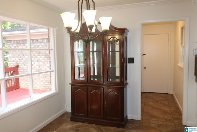 tiled dining room with crown molding and a notable chandelier