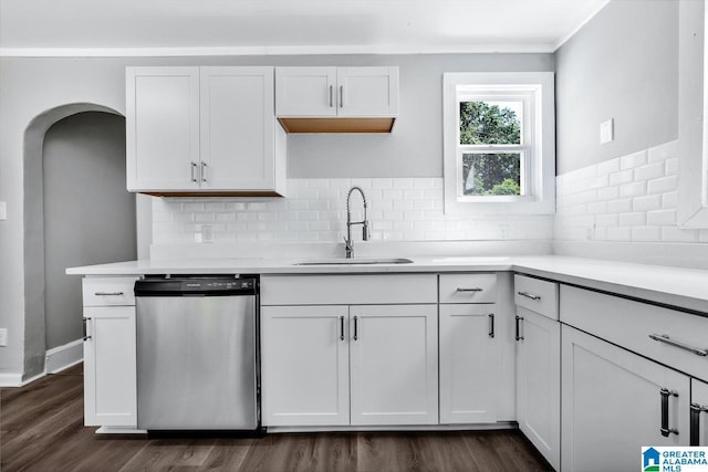 kitchen featuring sink, white cabinets, tasteful backsplash, stainless steel dishwasher, and dark wood-type flooring