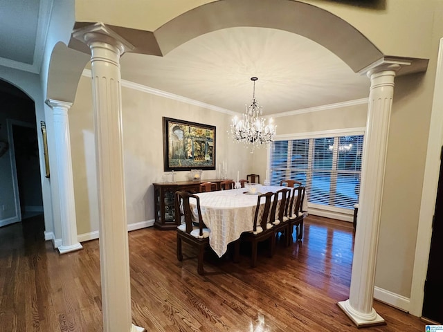 dining space with dark hardwood / wood-style floors, an inviting chandelier, and ornamental molding