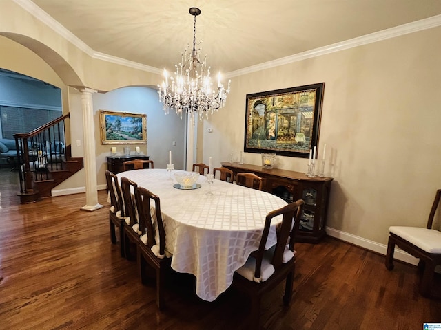 dining room with a notable chandelier, dark hardwood / wood-style flooring, crown molding, and decorative columns