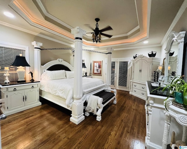 bedroom featuring dark hardwood / wood-style flooring, a raised ceiling, ceiling fan, and crown molding