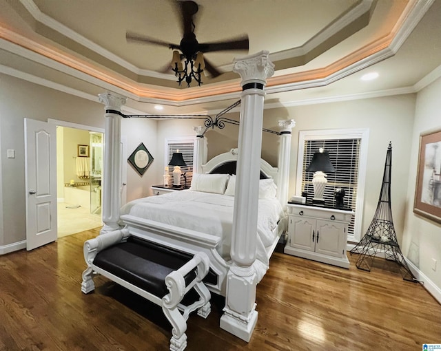 bedroom with ensuite bath, crown molding, hardwood / wood-style floors, and ceiling fan