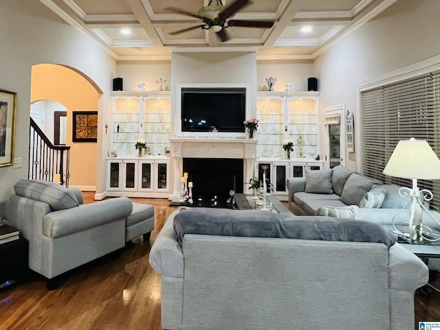 living room with ceiling fan, hardwood / wood-style floors, coffered ceiling, and ornamental molding