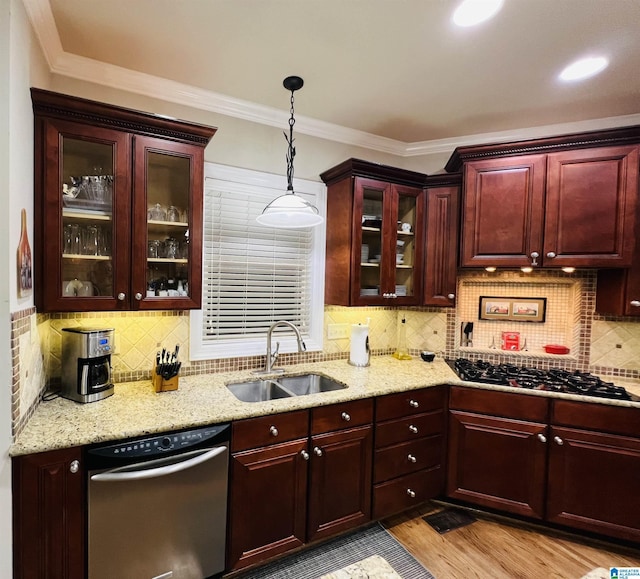 kitchen with sink, hanging light fixtures, decorative backsplash, ornamental molding, and stainless steel appliances