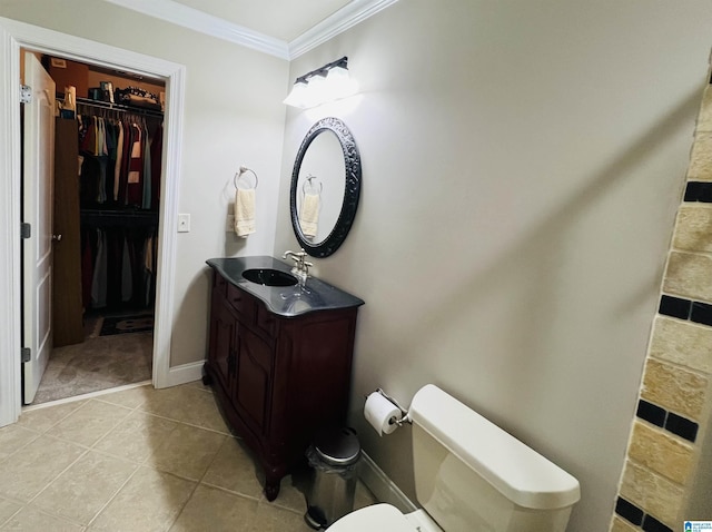 bathroom featuring tile patterned floors, toilet, vanity, and ornamental molding