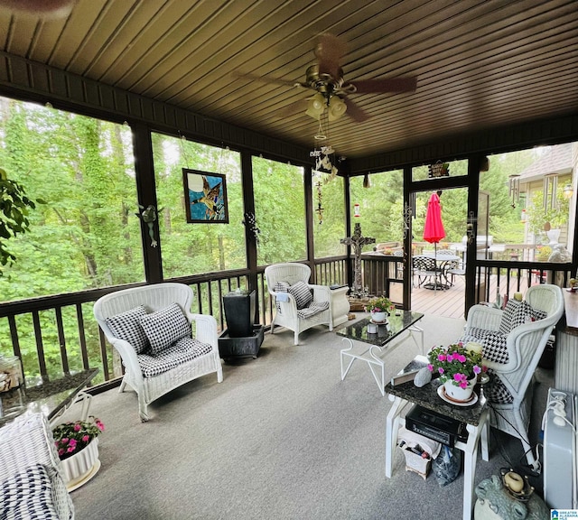 sunroom with ceiling fan and wooden ceiling