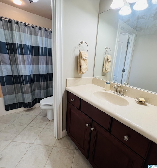 bathroom featuring tile patterned floors, walk in shower, vanity, and toilet