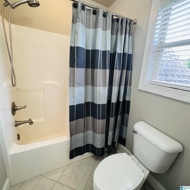 bathroom featuring tile patterned flooring, shower / tub combo, and toilet