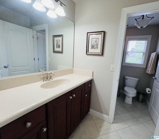 bathroom with tile patterned floors, vanity, and toilet