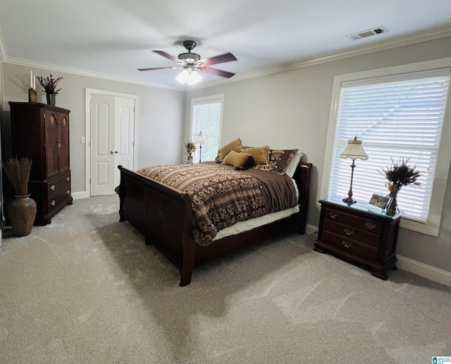 carpeted bedroom with multiple windows, ceiling fan, and crown molding