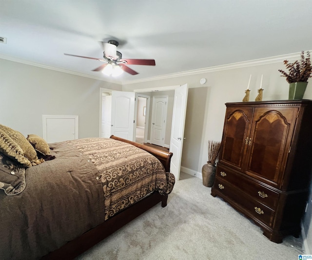 carpeted bedroom featuring ceiling fan and crown molding