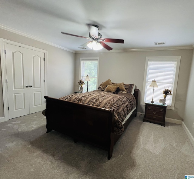 bedroom with light carpet, multiple windows, and ceiling fan