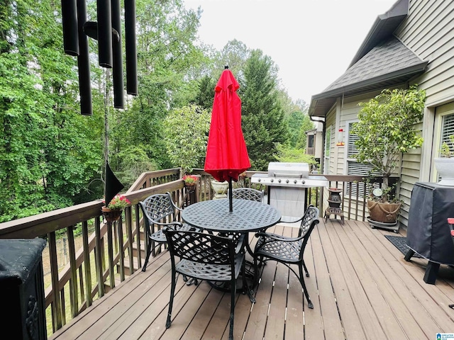 wooden terrace featuring a grill