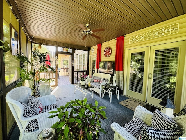 sunroom with ceiling fan and wood ceiling