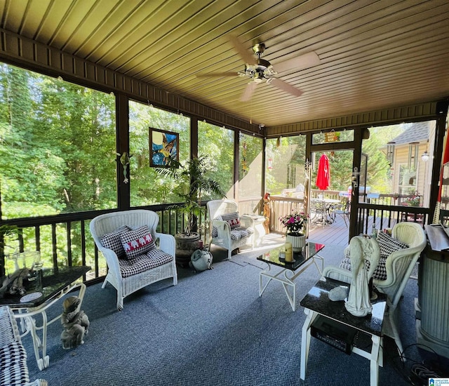 sunroom / solarium with ceiling fan and wooden ceiling