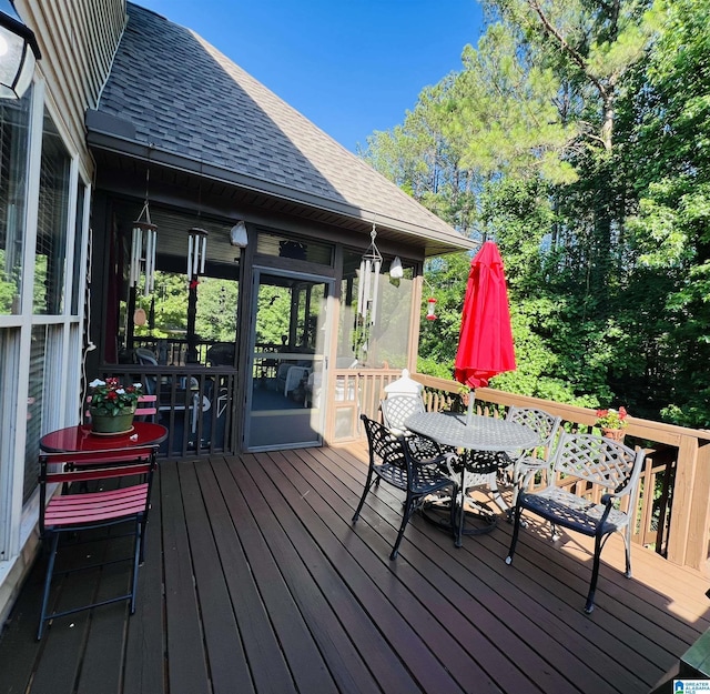 wooden deck featuring a sunroom