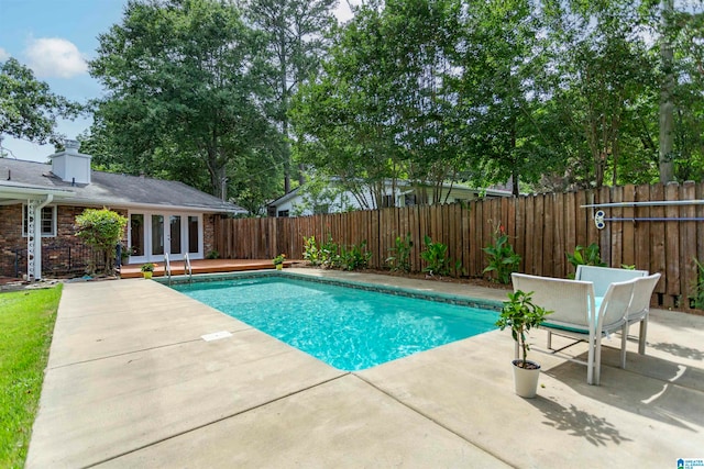 view of pool with a patio area and french doors