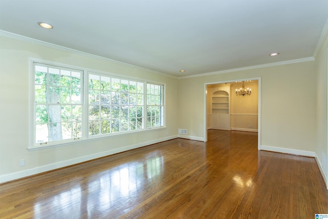 spare room with dark wood finished floors, plenty of natural light, and baseboards