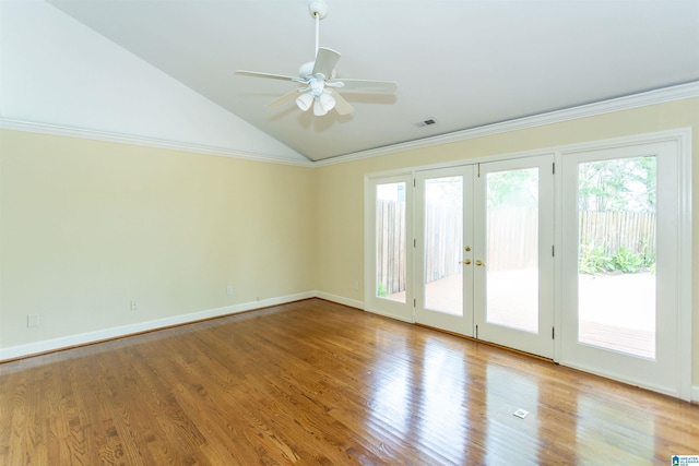 unfurnished room with light wood-style flooring, a ceiling fan, vaulted ceiling, french doors, and crown molding