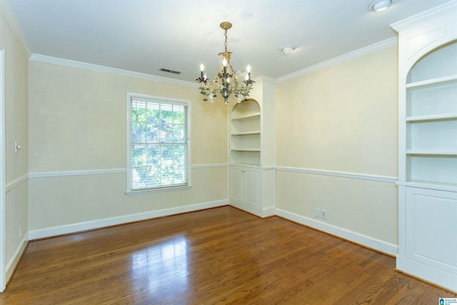 empty room with ornamental molding, dark wood-type flooring, baseboards, and built in features