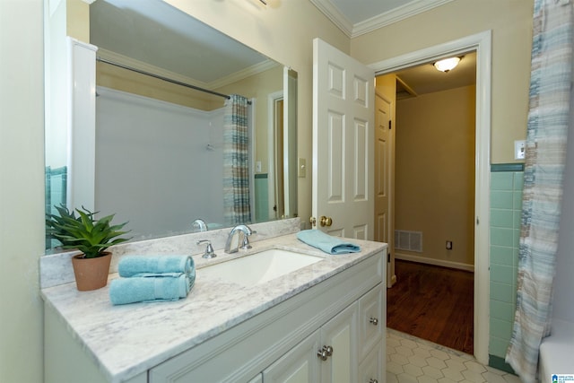 bathroom featuring vanity, visible vents, ornamental molding, tile patterned floors, and shower / bath combo with shower curtain