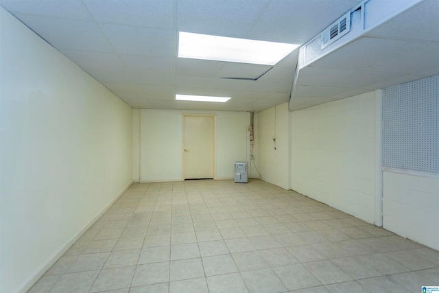 tiled spare room with a drop ceiling