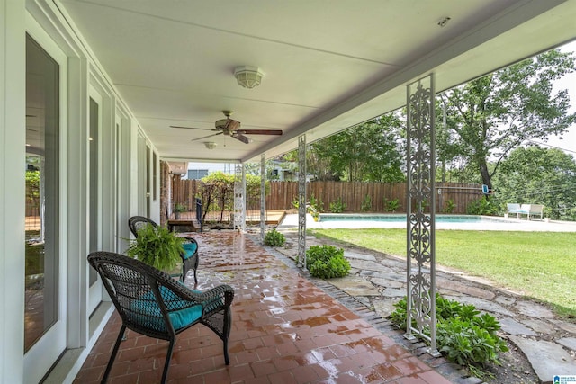 sunroom featuring a ceiling fan