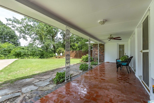 view of patio / terrace with a ceiling fan and fence